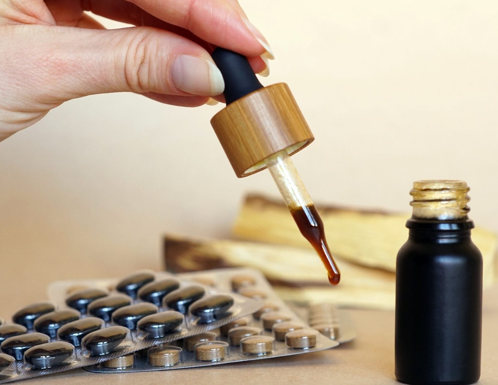 A brown natural medicine in a small bottle with a pipette